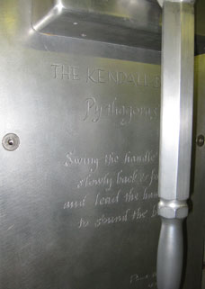 A metal wall with the words " the kennedy family " engraved on it.